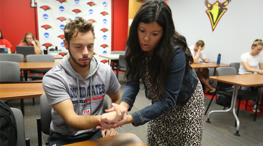 La Roche professor working with a health science student in the classroom